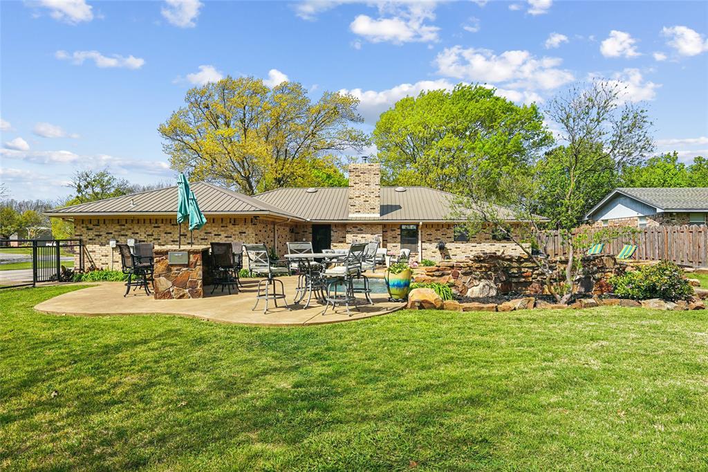 908 North Maple Street Muenster, TX 76252 - Photo 29 of 40 a view of a chairs and tables in the patio and a yard