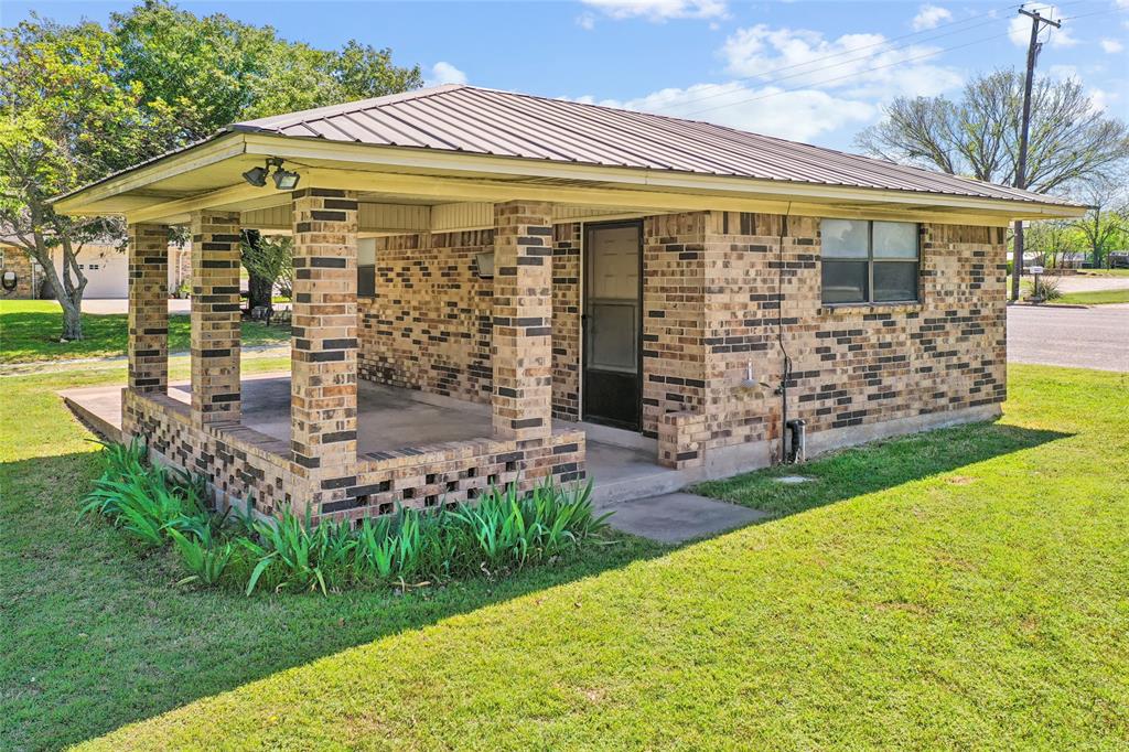 908 North Maple Street Muenster, TX 76252 - Photo 30 of 40 a view of a large building with a big yard and large trees