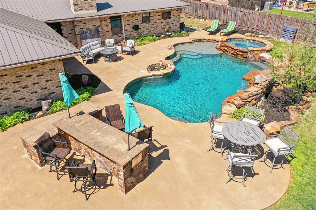 908 North Maple Street Muenster, TX 76252 - Photo 35 of 40 an aerial view of a house with garden space and swimming pool