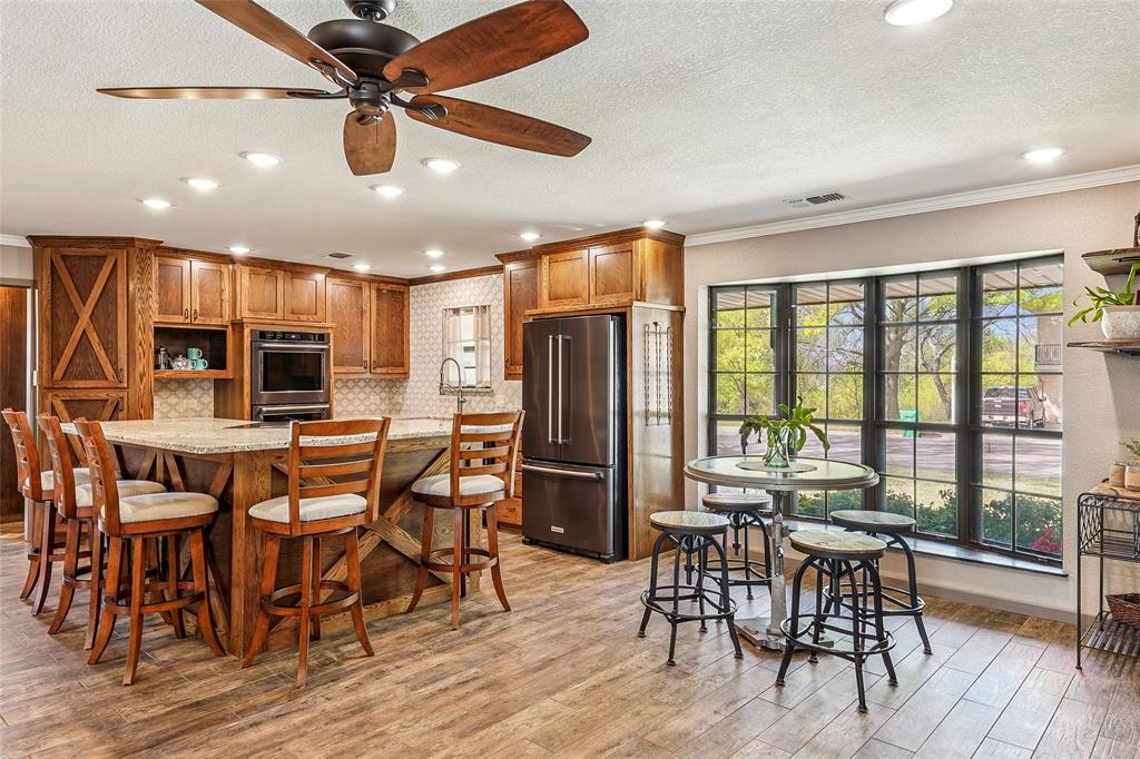 908 North Maple Street Muenster, TX 76252 - Photo 8 of 40 a view of a dining room with furniture window and wooden floor