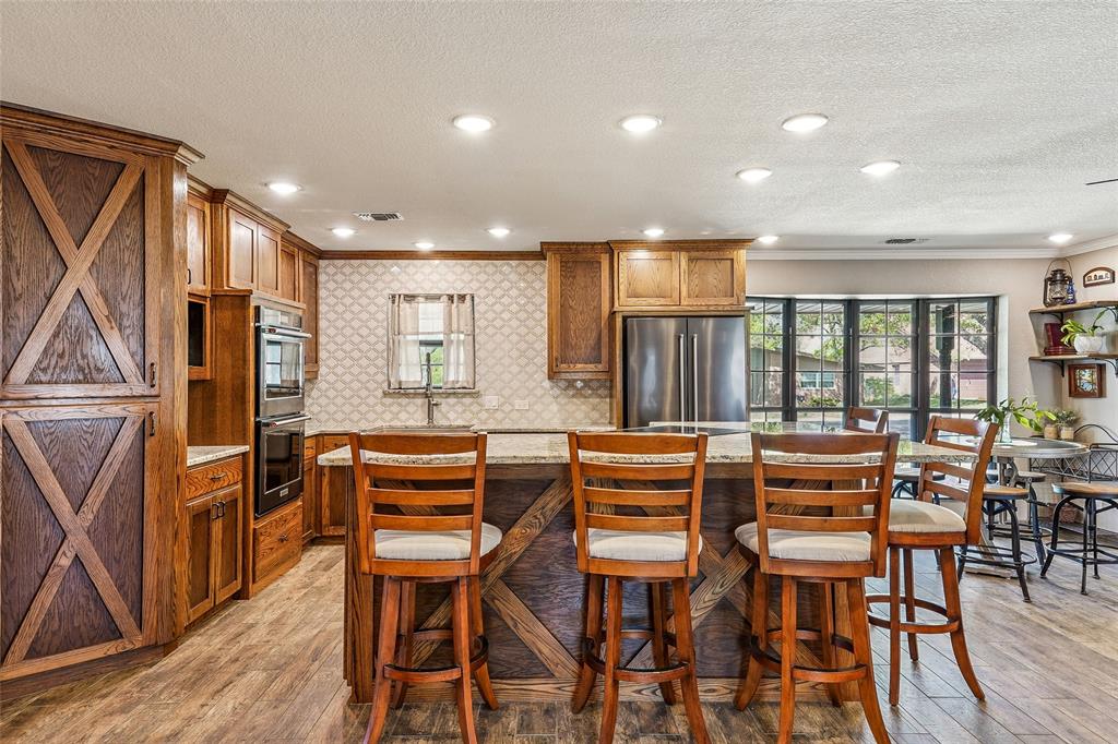 908 North Maple Street Muenster, TX 76252 - Photo 9 of 40 a dining room with furniture and wooden floor