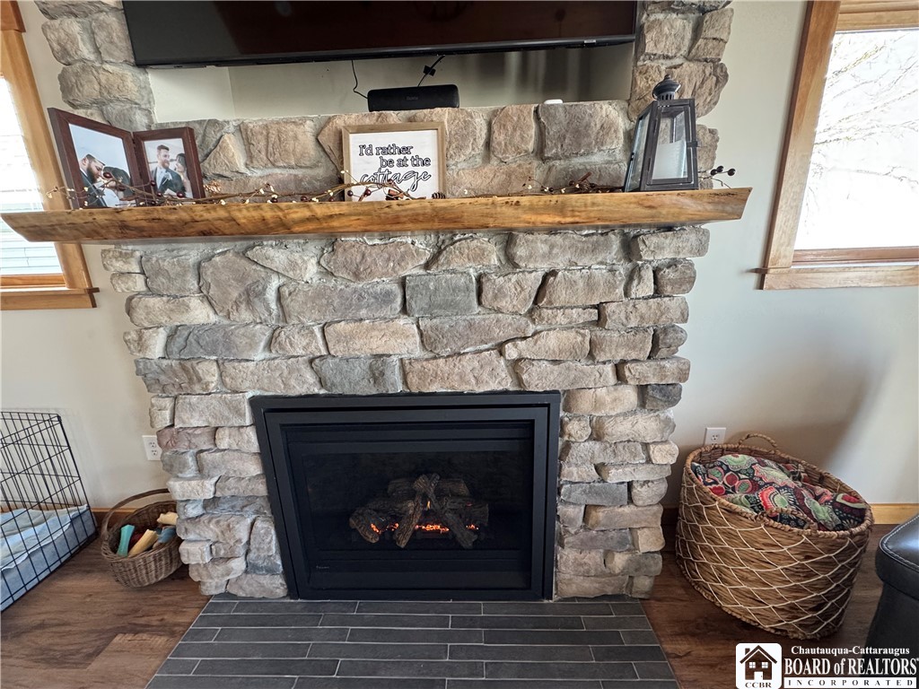 29 Loomis Bay Road Busti, NY 14710 - Photo 20 of 49 The stone fireplace, complemented by a black walnu