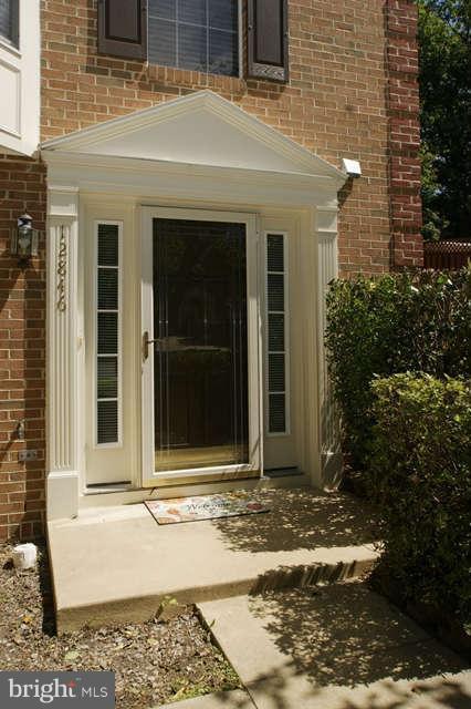 12846 Silvia Loop Woodbridge, VA 22192 - Photo 2 of 30 a front view of a house with a yard