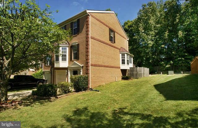 12846 Silvia Loop Woodbridge, VA 22192 - Photo 3 of 30 a front view of a house with a yard
