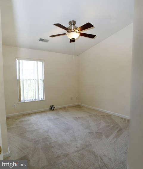 12846 Silvia Loop Woodbridge, VA 22192 - Photo 23 of 30 an empty room with windows and ceiling fan view