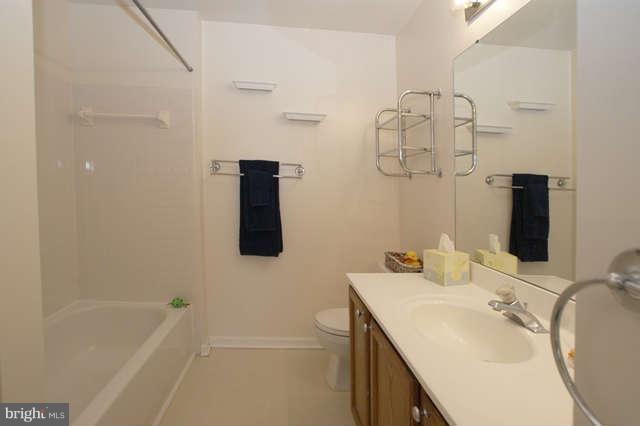 12846 Silvia Loop Woodbridge, VA 22192 - Photo 27 of 30 a bathroom with a sink vanity tub and shower