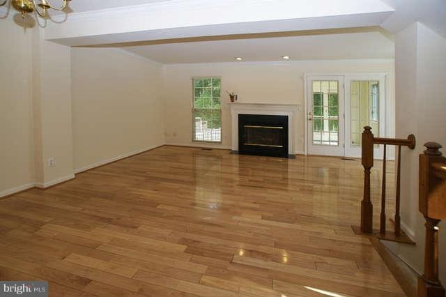 12846 Silvia Loop Woodbridge, VA 22192 - Photo 10 of 30 a view of empty room with wooden floor and fireplace
