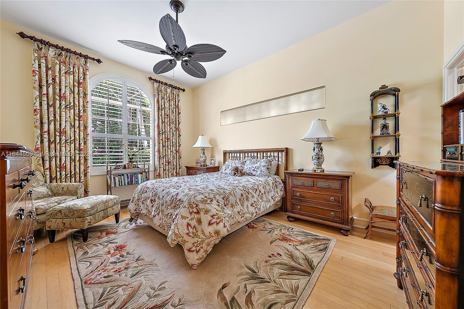 167 North Village Way Jupiter, FL 33458 - Photo 11 of 18 a bedroom with a bed dresser and a chandelier