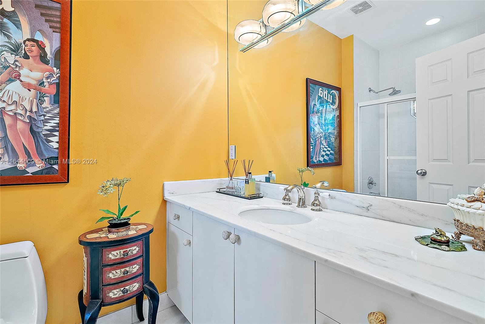 167 North Village Way Jupiter, FL 33458 - Photo 14 of 18 a bathroom with a sink and a mirror