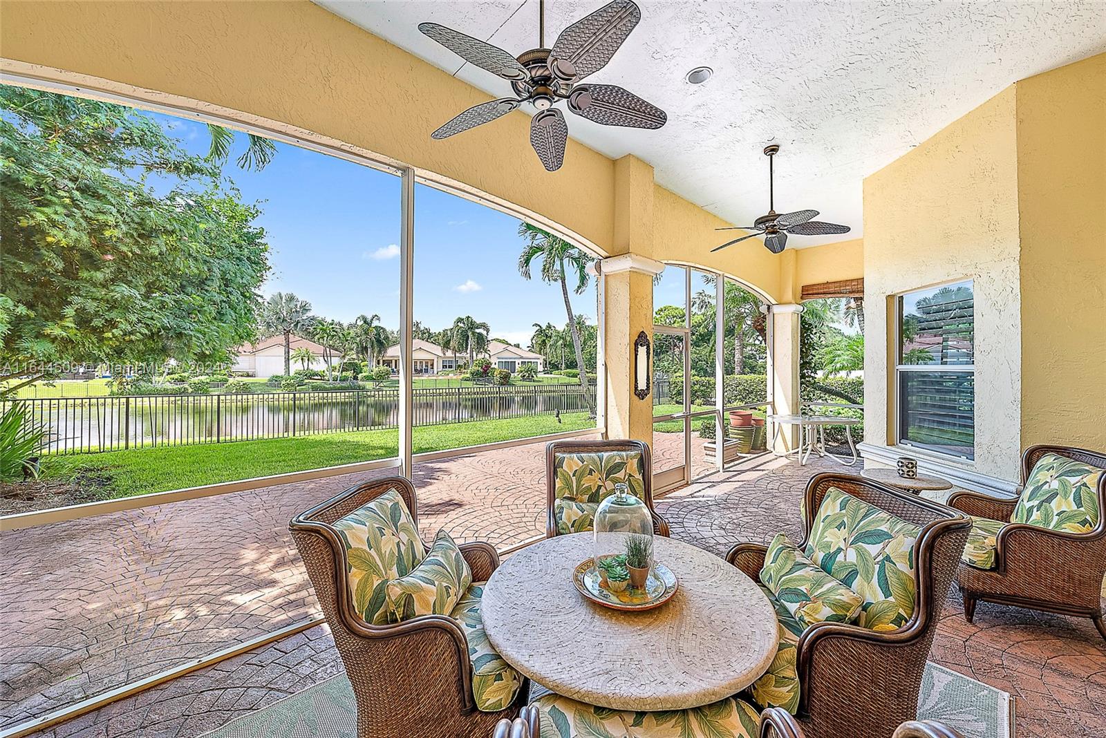 167 North Village Way Jupiter, FL 33458 - Photo 15 of 18 a view of a patio with a table chairs and a backyard