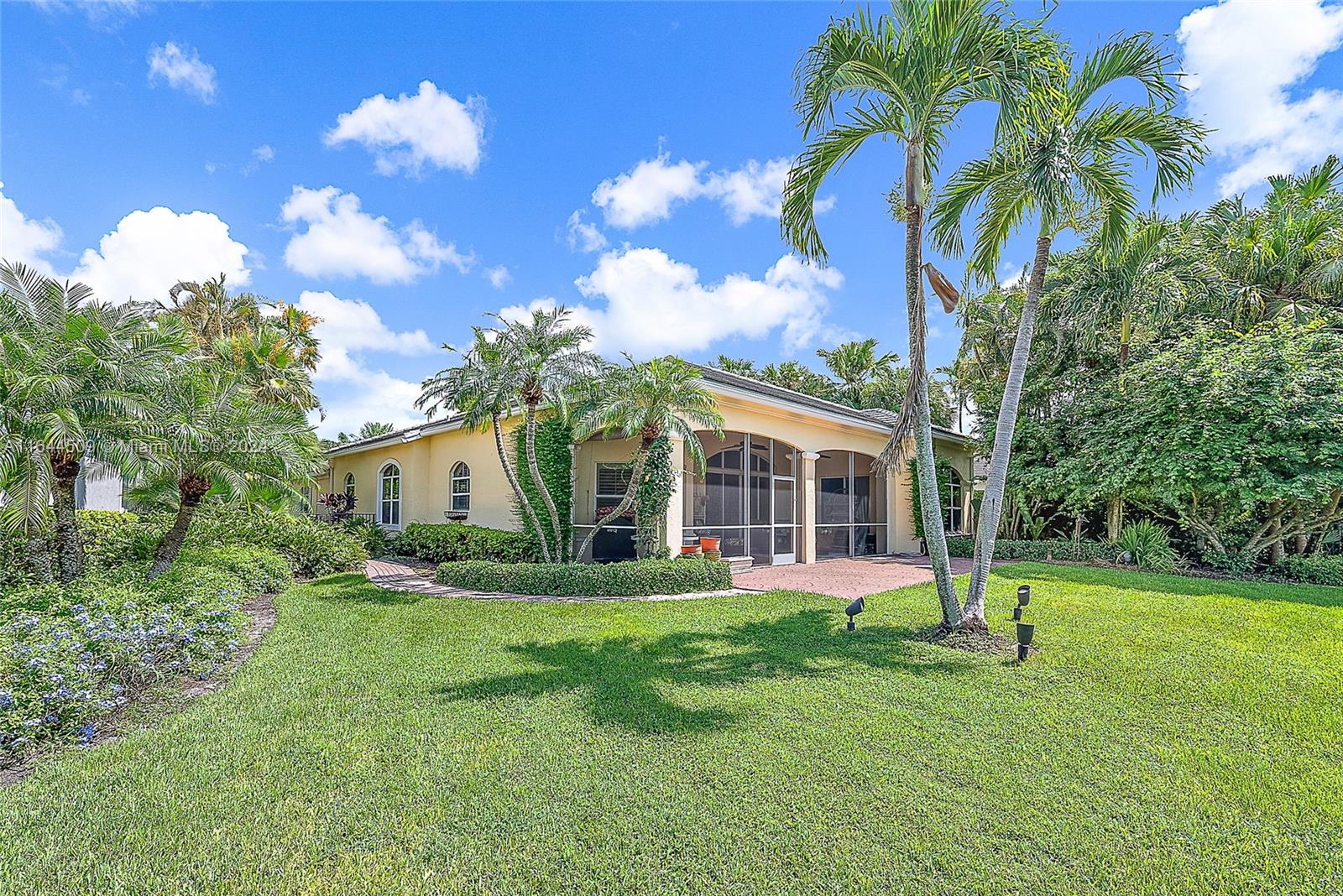 167 North Village Way Jupiter, FL 33458 - Photo 16 of 18 a view of a house with a yard and potted plants