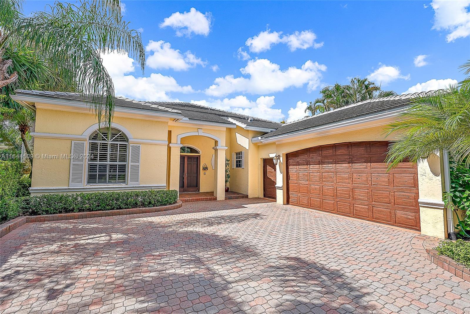 167 North Village Way Jupiter, FL 33458 - Photo 3 of 18 a front view of a house with a yard