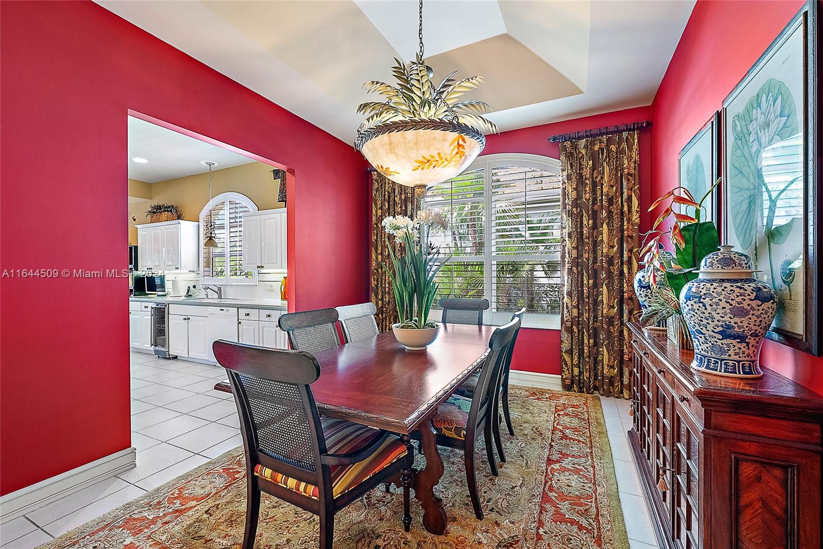 167 North Village Way Jupiter, FL 33458 - Photo 7 of 18 a view of a dining room with furniture and a chandelier