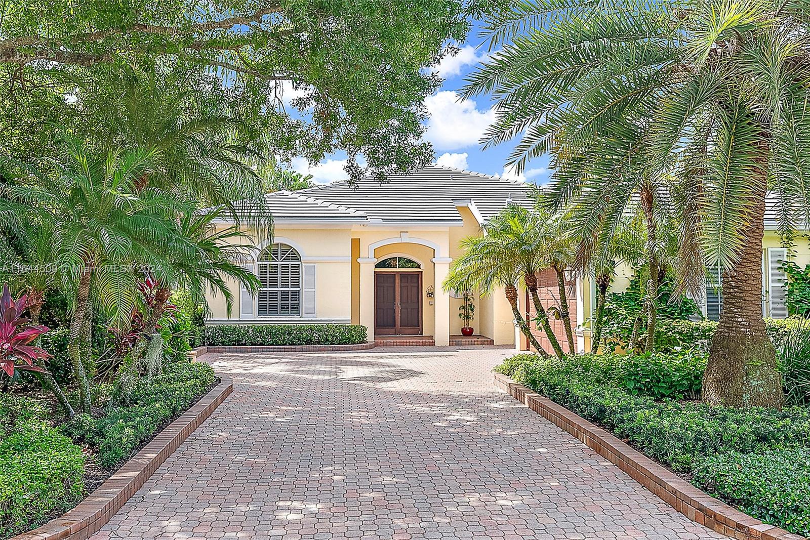 167 North Village Way Jupiter, FL 33458 - Photo 8 of 18 a front view of a house with a garden