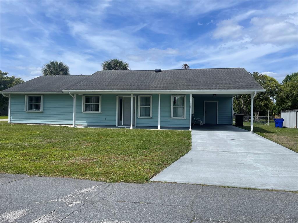 1820 6th Street St. Cloud, FL 34769 - Photo 1 of 1 a front view of a house with a garden