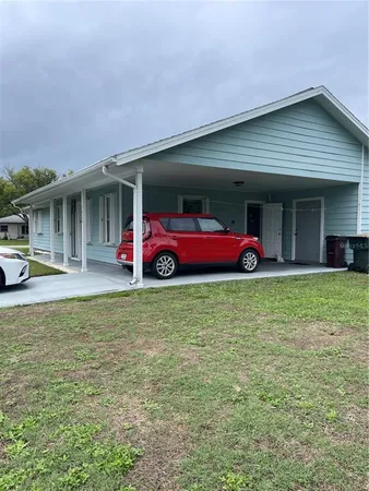 a front view of house with outdoor seating and yard
