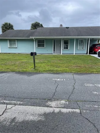 a front view of a house with a yard and a garage