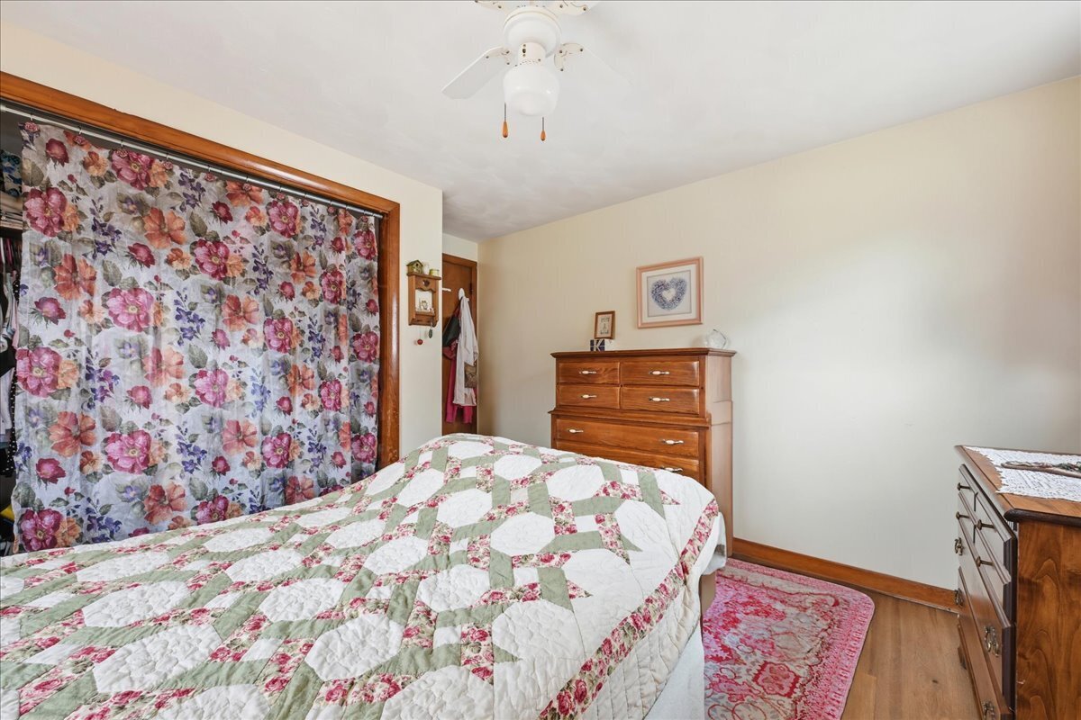 7 Barn Road Ledyard, CT 06339 - Photo 13 of 26 a bedroom with a bed and a lamp on the dresser