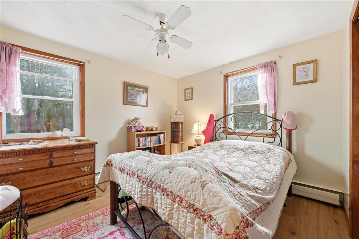 7 Barn Road Ledyard, CT 06339 - Photo 14 of 26 a bedroom with a bed and wooden floor