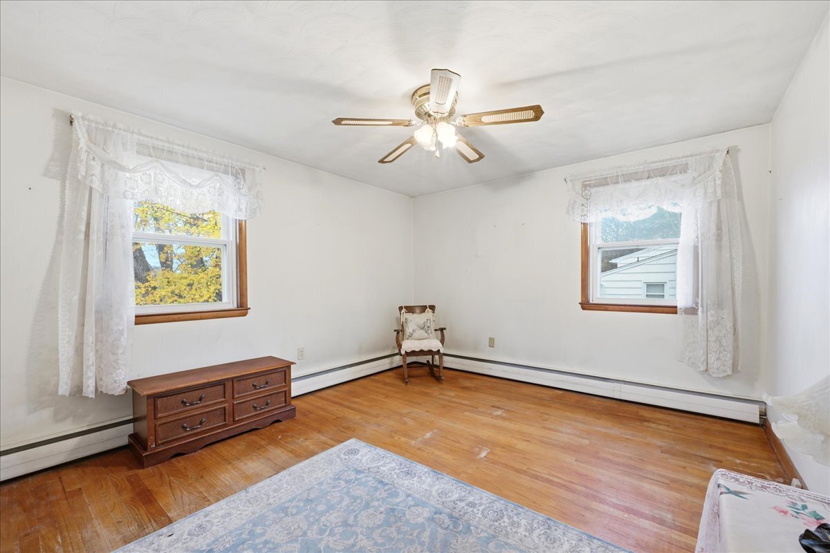 7 Barn Road Ledyard, CT 06339 - Photo 16 of 26 an empty room with windows and ceiling fan