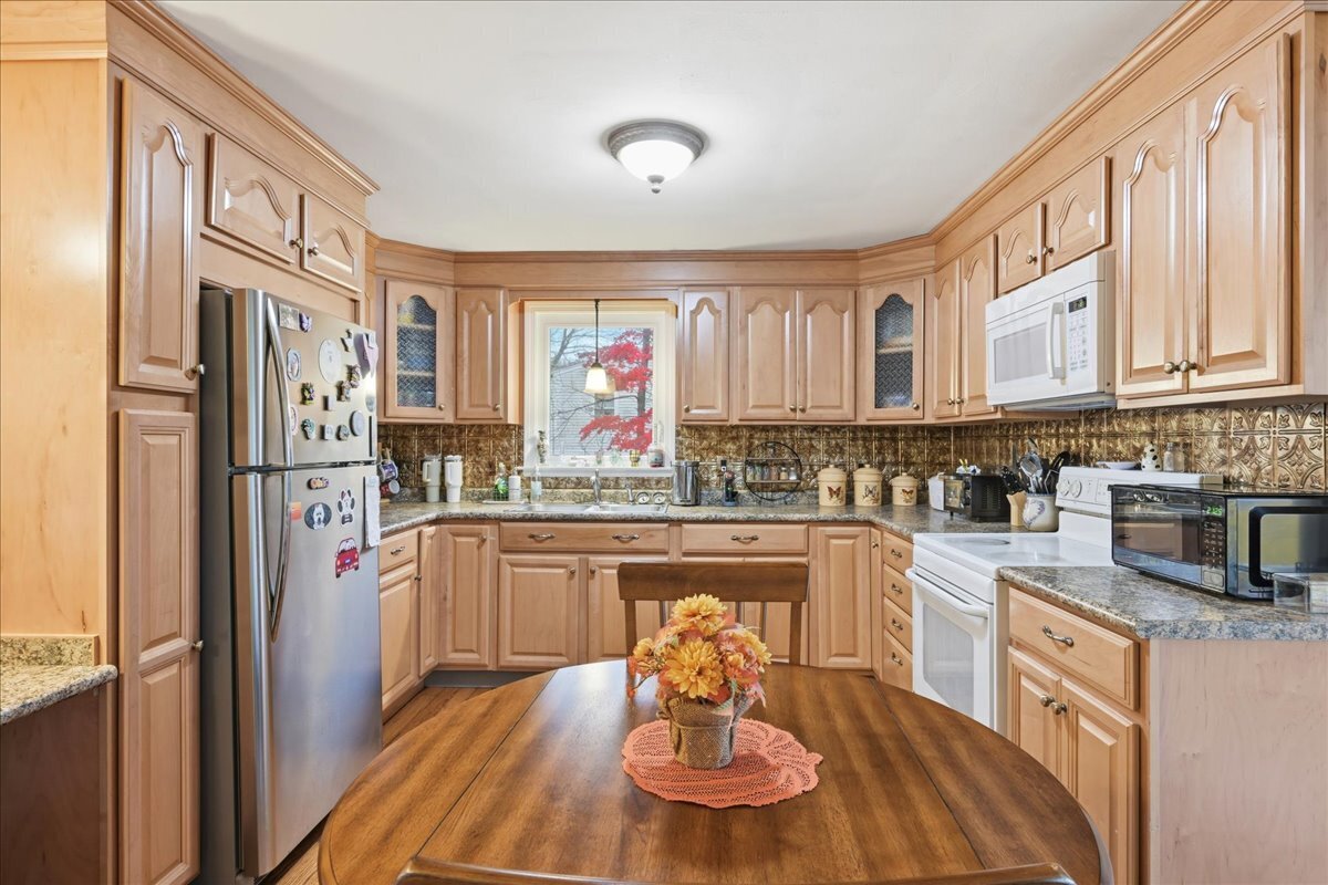 7 Barn Road Ledyard, CT 06339 - Photo 8 of 26 a kitchen with stainless steel appliances granite countertop a refrigerator and a stove top oven