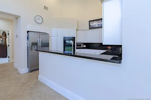 a view of a house with backyard porch and sitting area