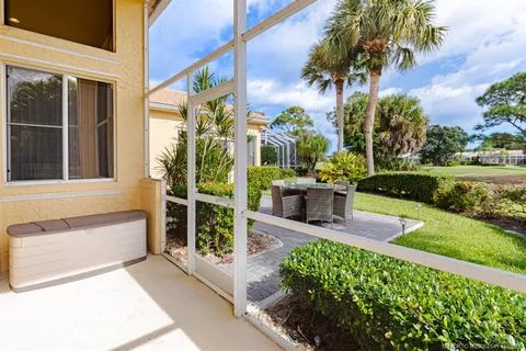 a spacious bedroom with a large bed and a chandelier