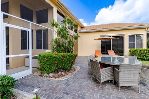 a bedroom with a large bed and a potted plant