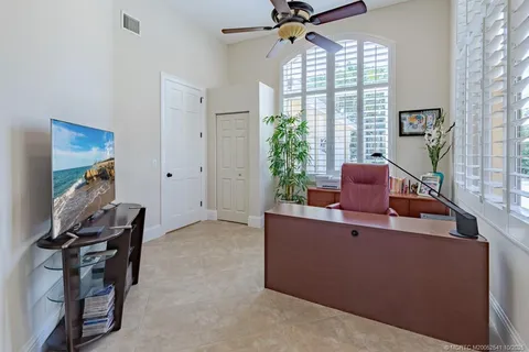 a view of a patio with table and chairs potted plants and large tree