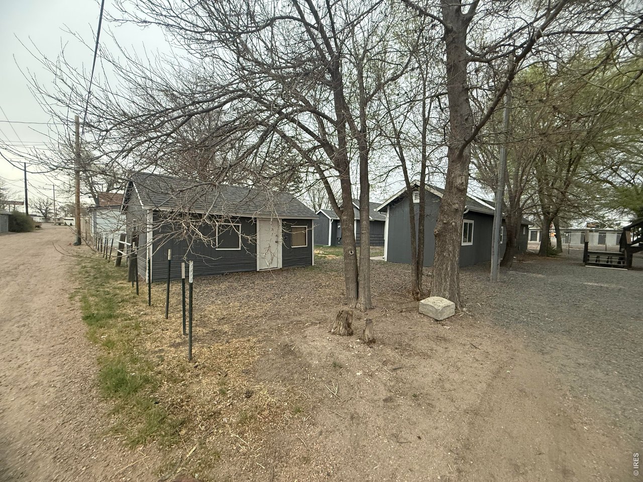 703 North 2nd Street Sterling, CO 80751 - Photo 16 of 19 a view of a yard with a house and a tree