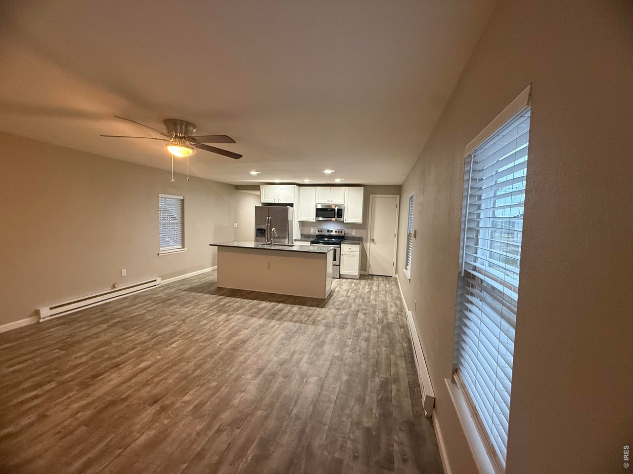 703 North 2nd Street Sterling, CO 80751 - Photo 18 of 19 a view of a kitchen with wooden floor and electronic appliances