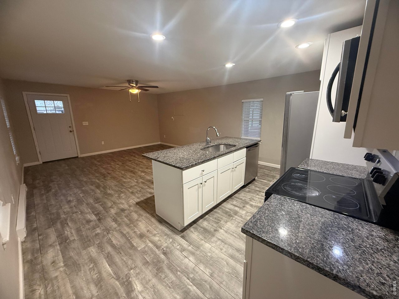 703 North 2nd Street Sterling, CO 80751 - Photo 19 of 19 a kitchen with stainless steel appliances granite countertop a sink a stove and a refrigerator