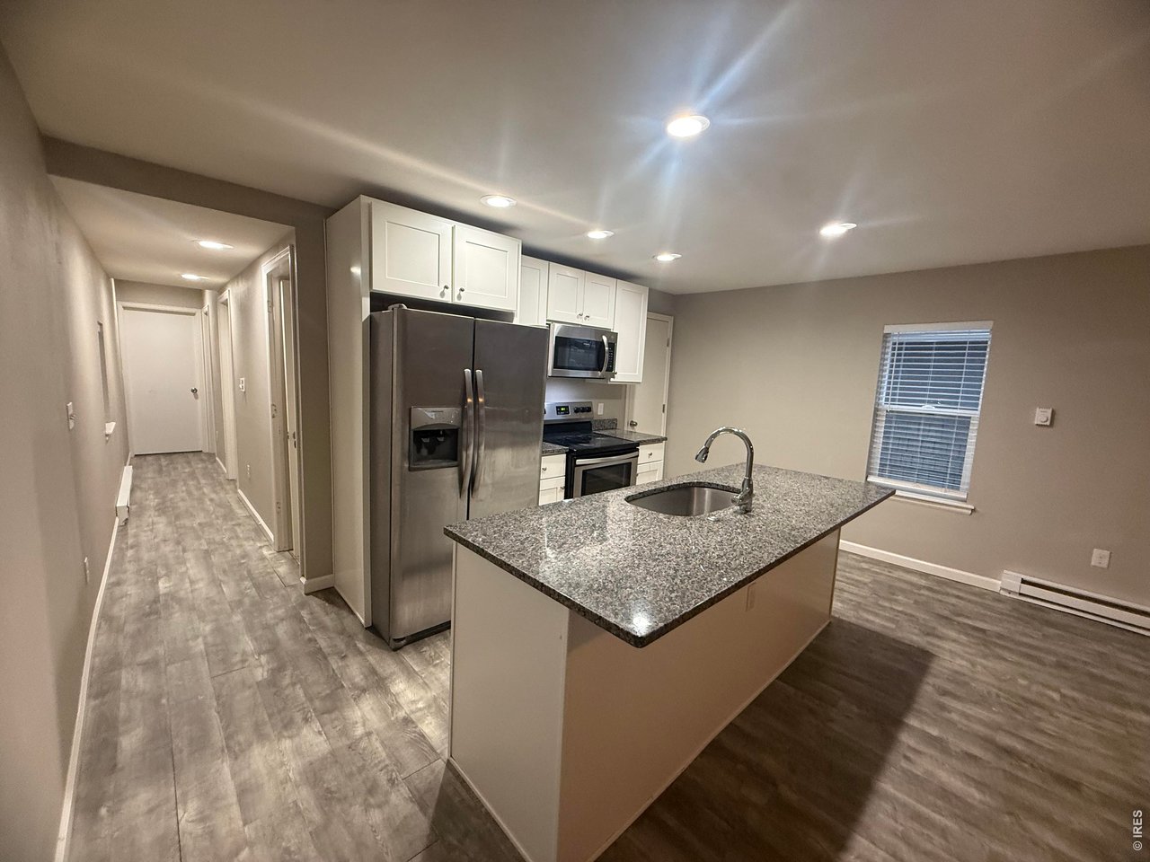 703 North 2nd Street Sterling, CO 80751 - Photo 5 of 19 a kitchen with stainless steel appliances granite countertop a sink dishwasher a refrigerator and a microwave