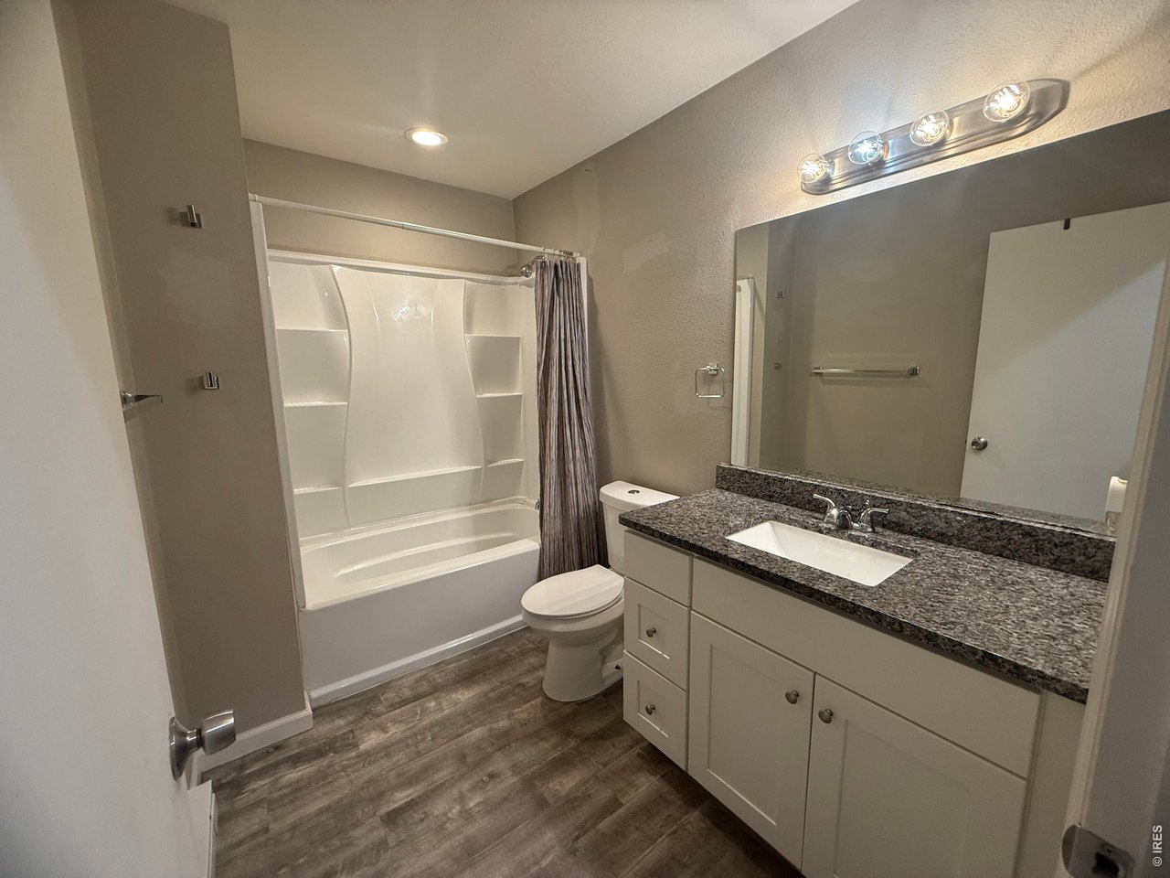 703 North 2nd Street Sterling, CO 80751 - Photo 6 of 19 a bathroom with a granite countertop sink toilet and shower