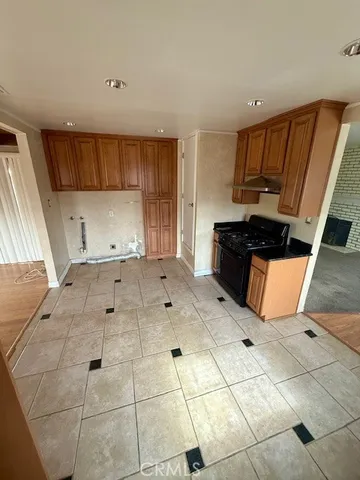 a view of kitchen with wooden cabinets