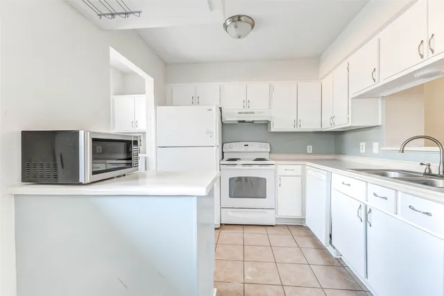 a kitchen with a stove top oven sink and cabinets