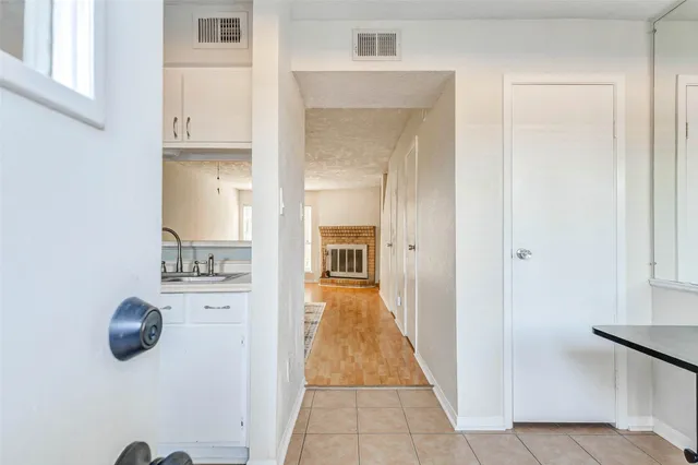 a view of a hallway with wooden floor and closet