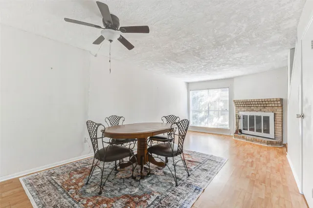 a dining room with furniture and wooden floor