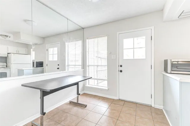 a room with pool table and windows