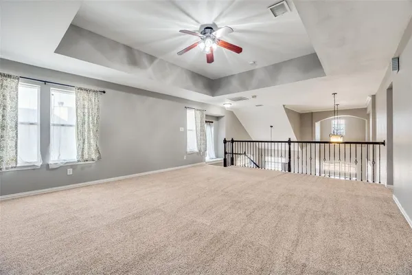 a view of a livingroom with a ceiling fan and window