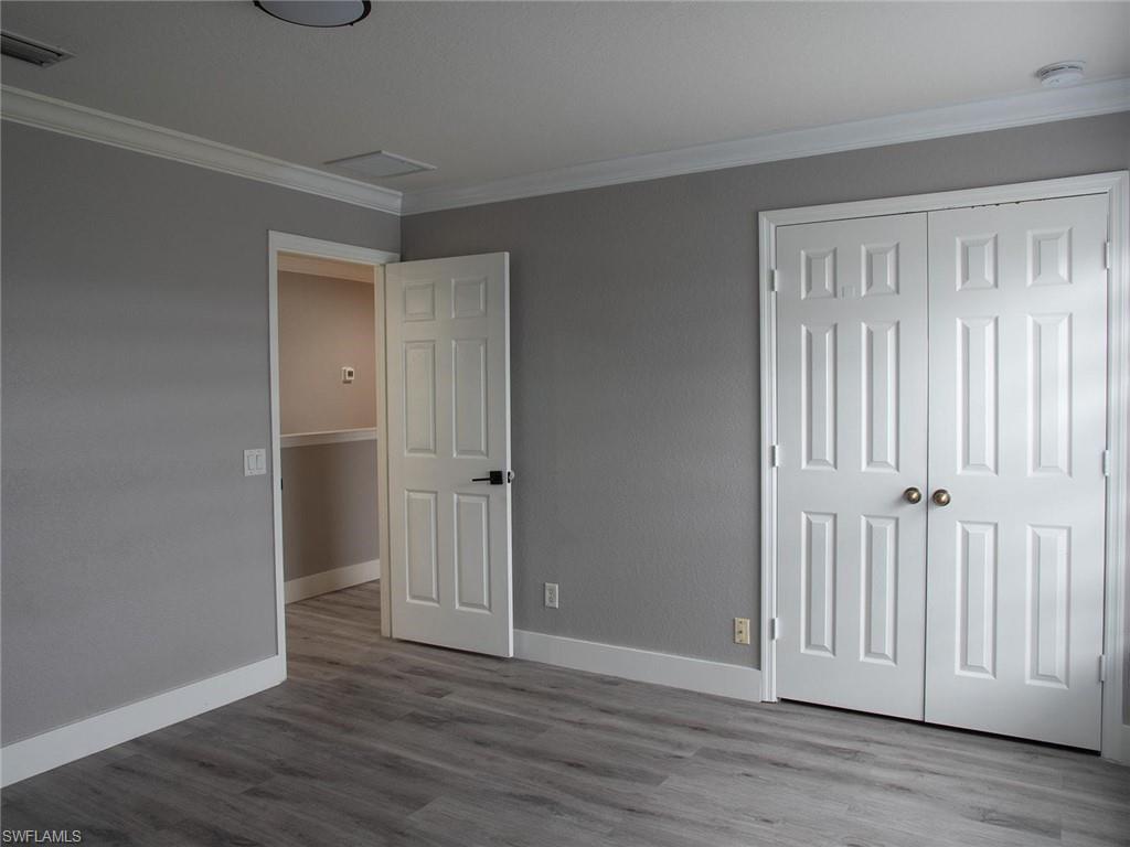 2822 Inlet Cove Lane West Naples, FL 34120 - Photo 15 of 23 an empty room with wooden floor & closet area