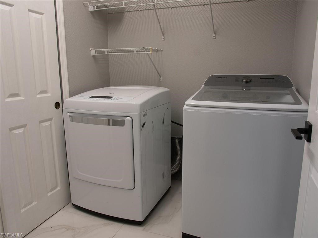 2822 Inlet Cove Lane West Naples, FL 34120 - Photo 20 of 23 a utility room with dryer and washer