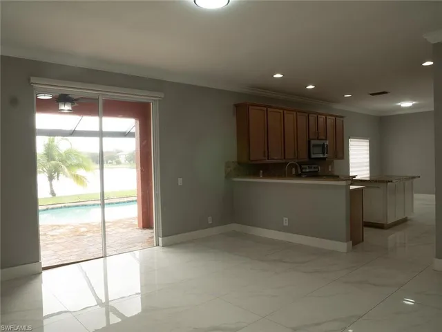a kitchen with a large window appliances and cabinets