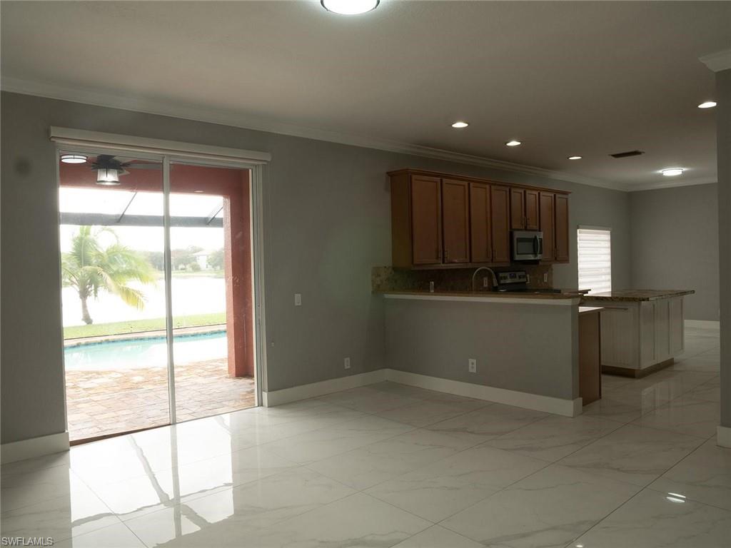2822 Inlet Cove Lane West Naples, FL 34120 - Photo 4 of 23 a kitchen with a large window appliances and cabinets