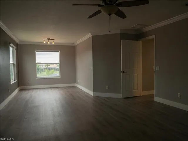 a view of a small space with wooden floor and a window