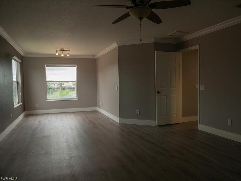 2822 Inlet Cove Lane West Naples, FL 34120 - Photo 10 of 23 an empty room with wooden floor cabinet and windows