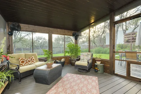 a living room with furniture and a floor to ceiling window