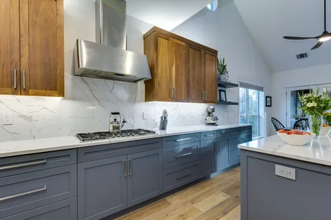 a kitchen with stainless steel appliances a sink stove and cabinets
