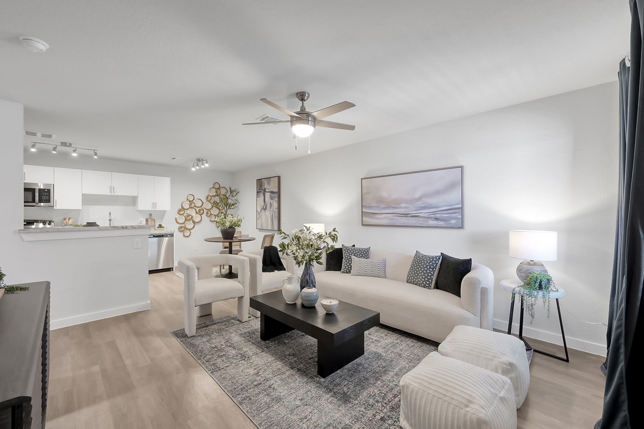 a living room with furniture and view of kitchen