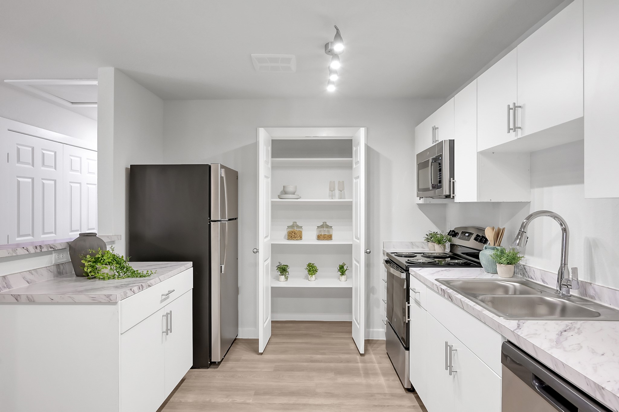 3450 Barker Cypress Road, Unit 2205 Houston, TX 77084 - Photo 11 of 21 a kitchen with a refrigerator sink and white cabinets